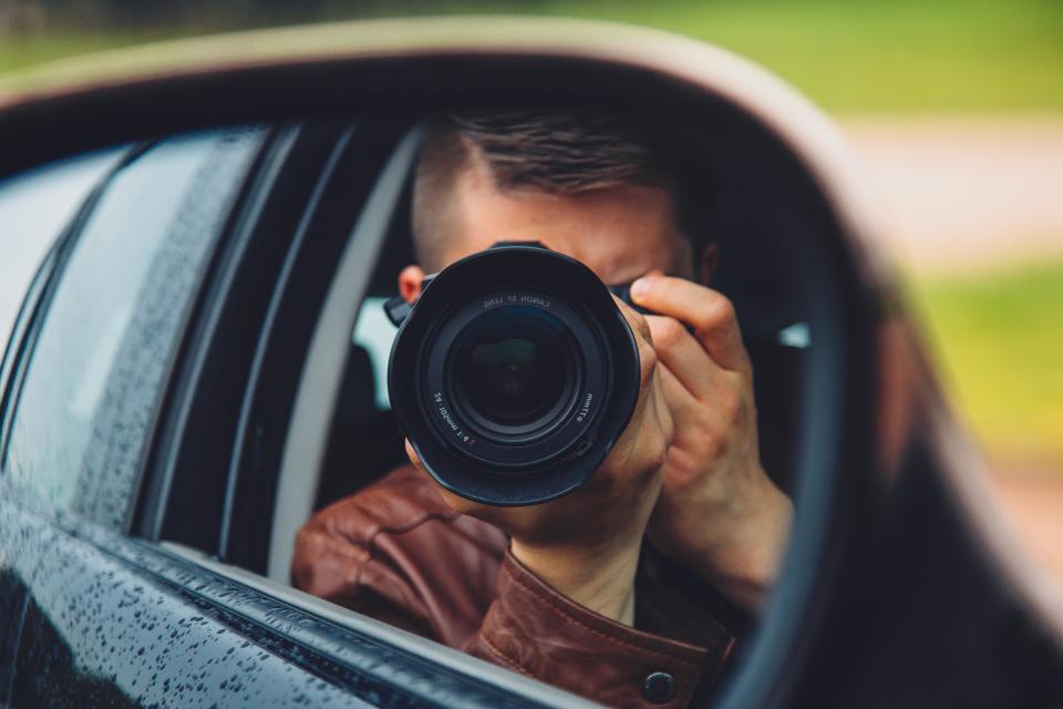 A photojournalist raising a camera to take a picture