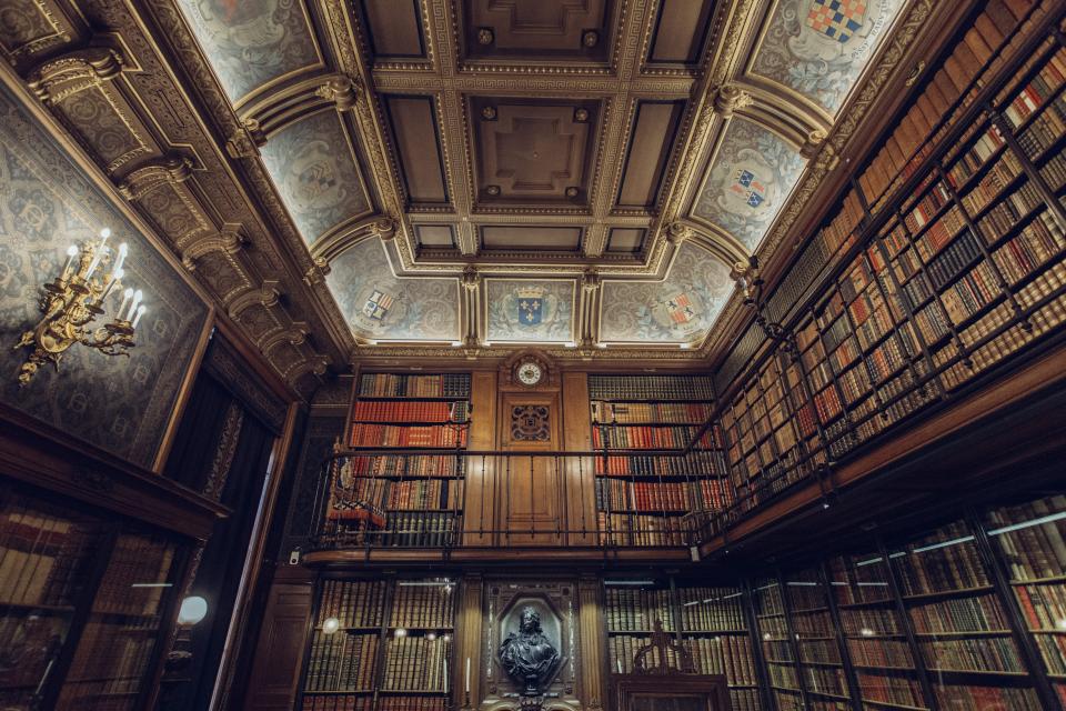 A historic library reading room lined with books, representing the Trust's archive and resources
